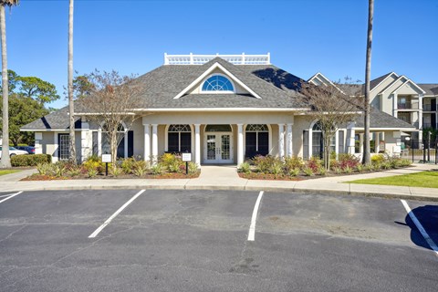 A white building with a blue window and a black roof.