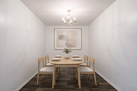 A dining room with a table set for two.
