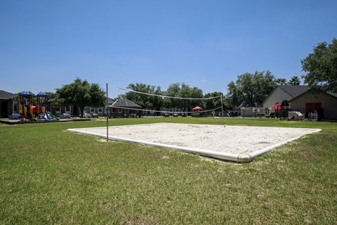 an old sand volleyball court in the middle of a field