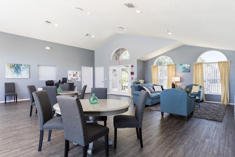 a living room with blue chairs and a table