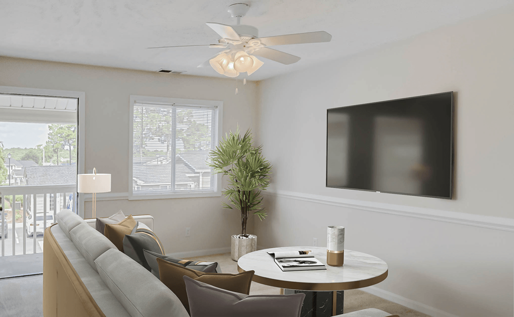 a living room with a couch and a table and a tv at Patriot Point Apartment Homes, Spring Lake, 28390 