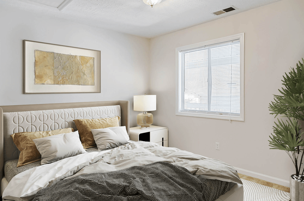 a bedroom with a bed and a window at Patriot Point Apartment Homes, North Carolina 