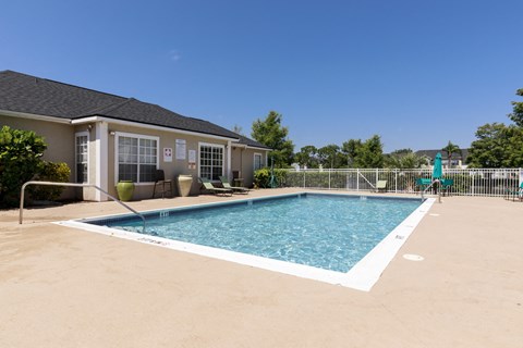 Swimming Pool with Lounge Seating and Building Exterior in the Background