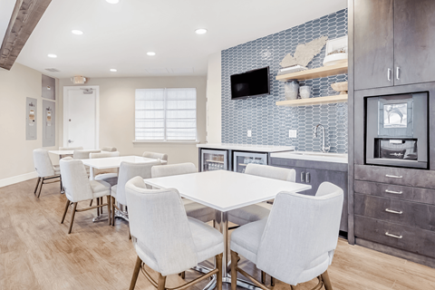 A modern kitchen with a dining table and chairs.