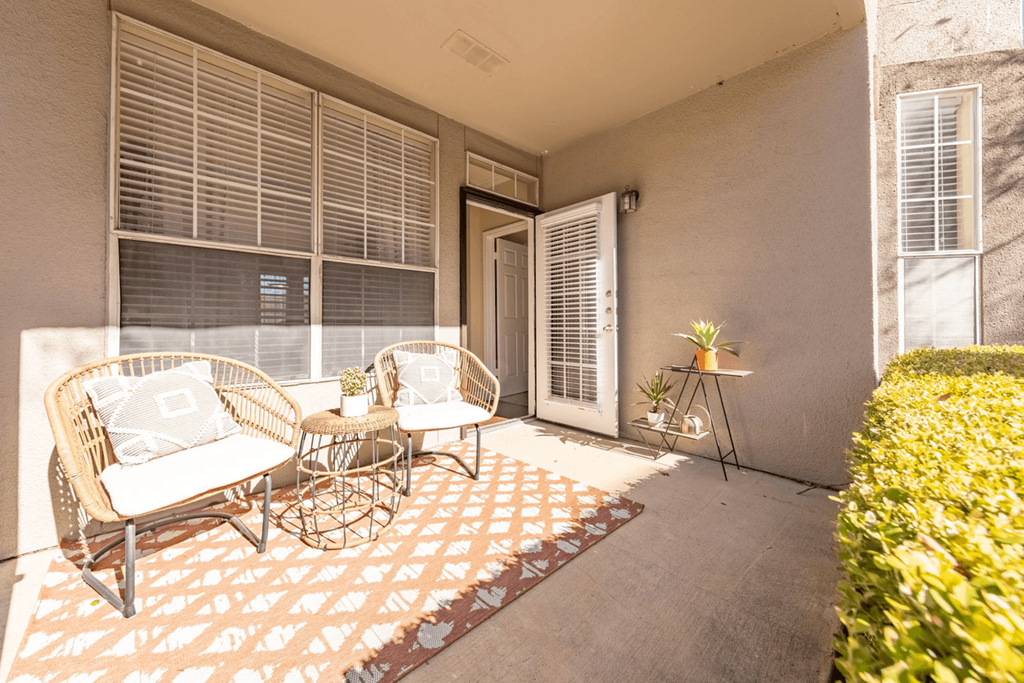 a patio with two chairs and a table
