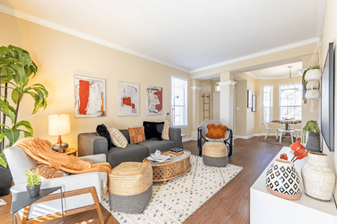 a living room with beige walls and a white rug