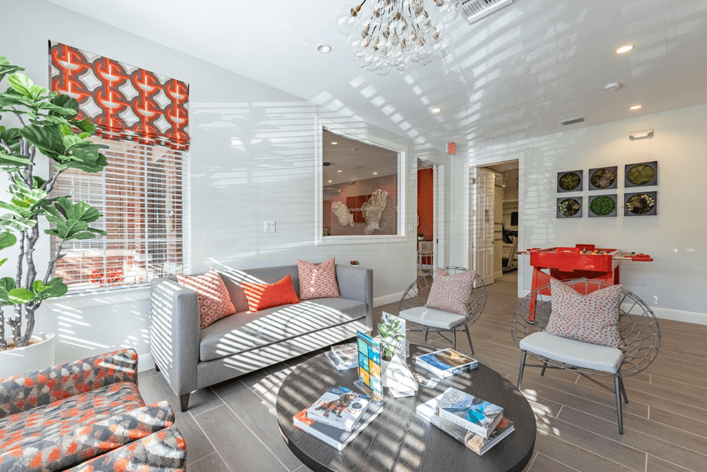 a living room filled with furniture and a chandelier