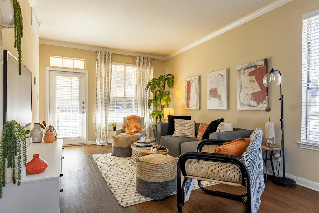 a living room filled with furniture and a large window