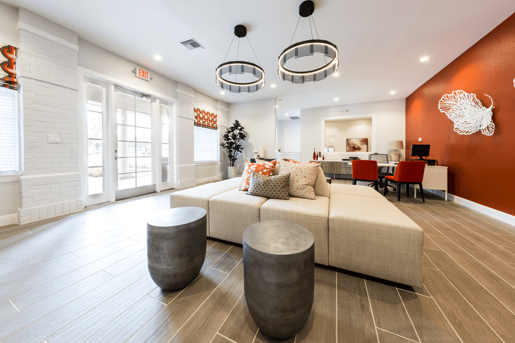 a resident clubhouse with a couch and tables