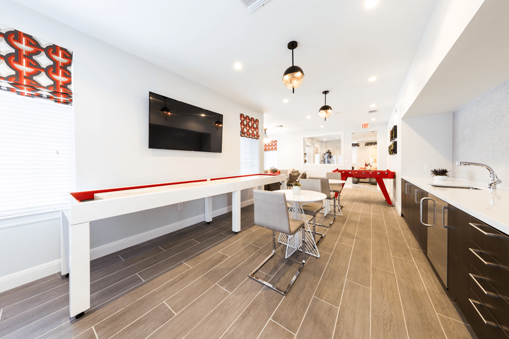 a room with a pool table and a flat screen tv