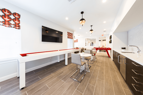 a room with a pool table and a flat screen tv