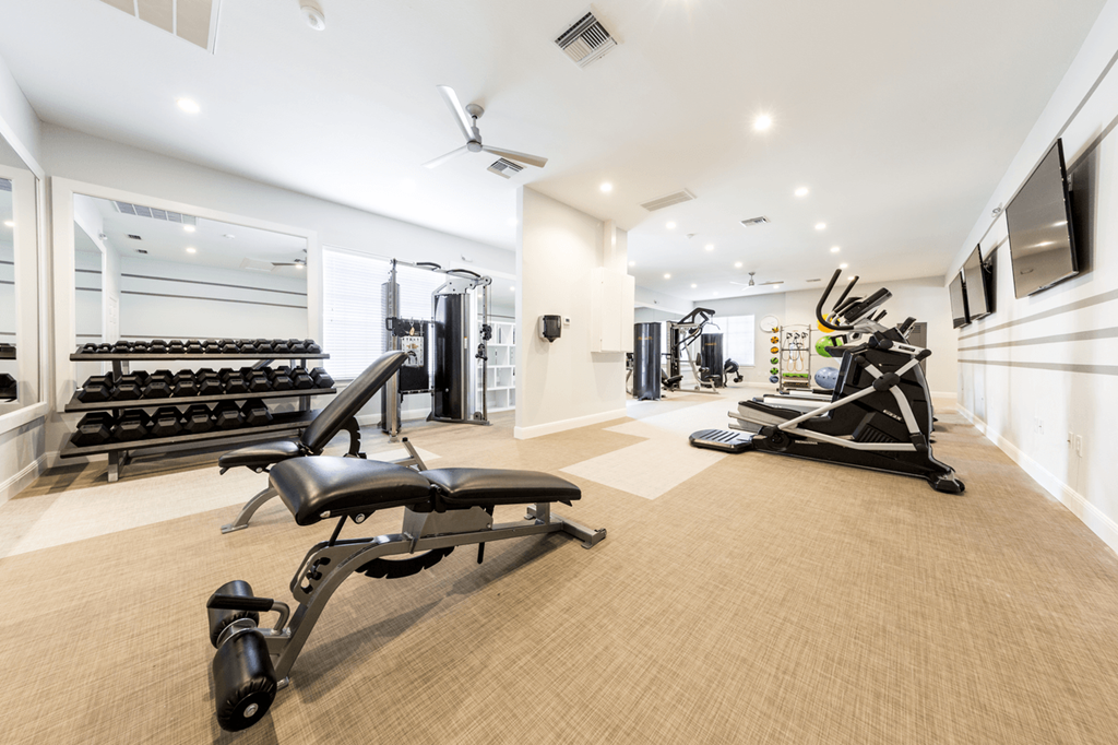 a gym with treadmills and other exercise equipment
