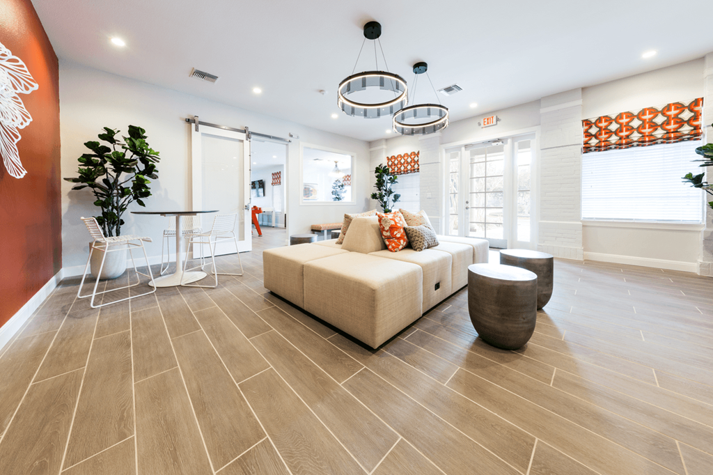 a living room with a couch table and chairs