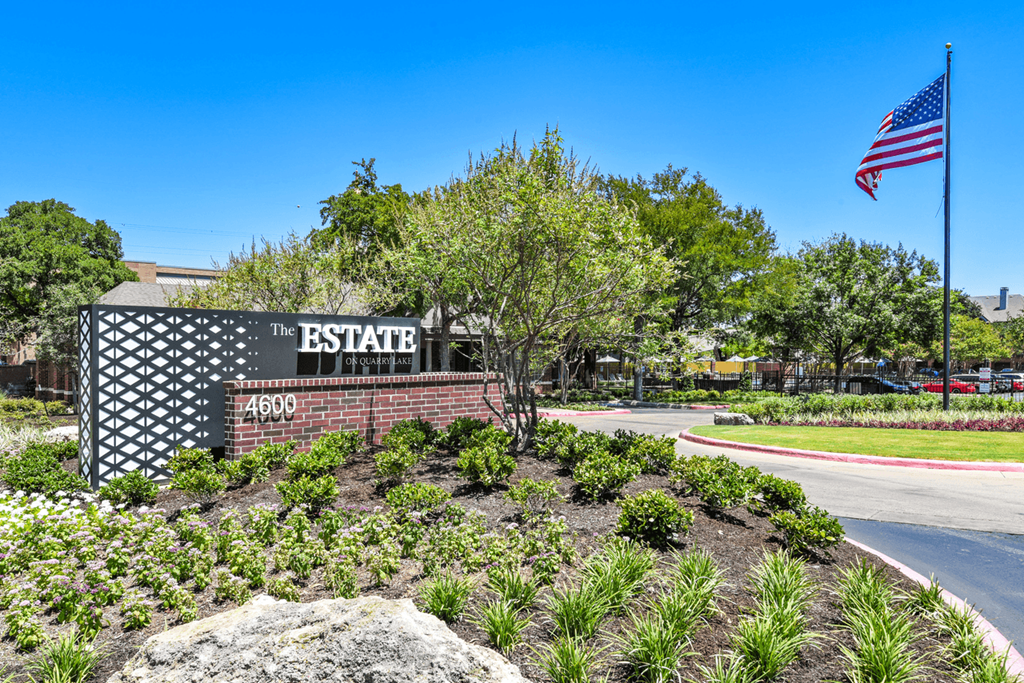 an american flag flies in front of the estate office