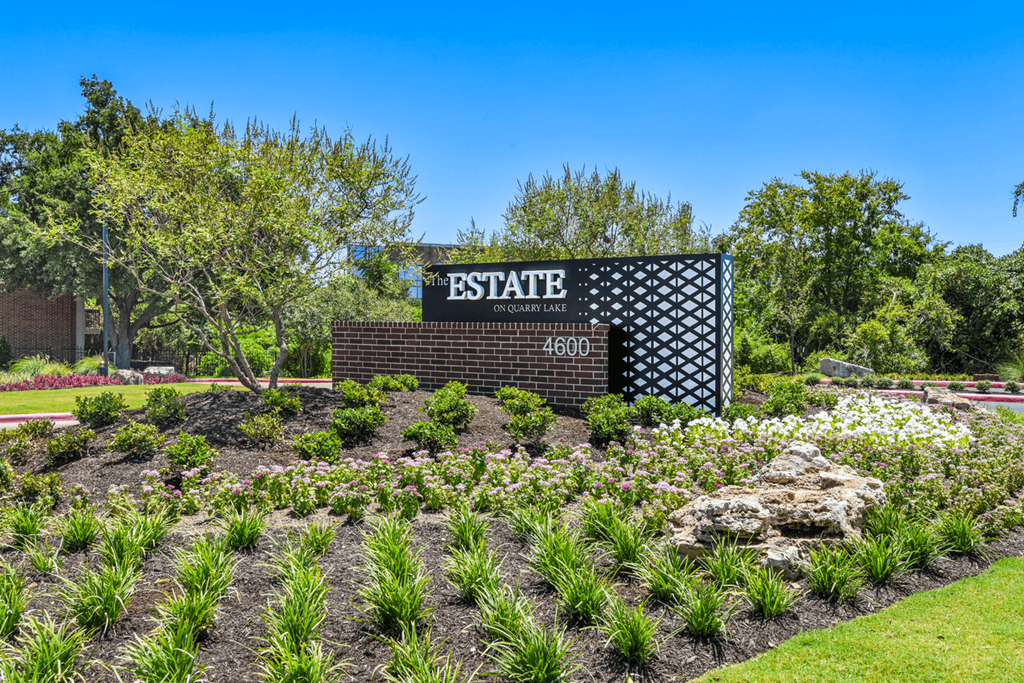 a landscaped garden with a sign that says estate
