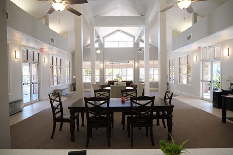 A dining room with a table set for six.