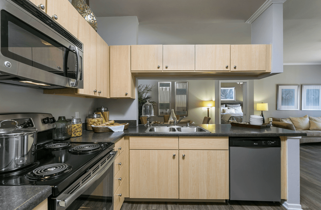 a kitchen with a stove top oven next to a sink