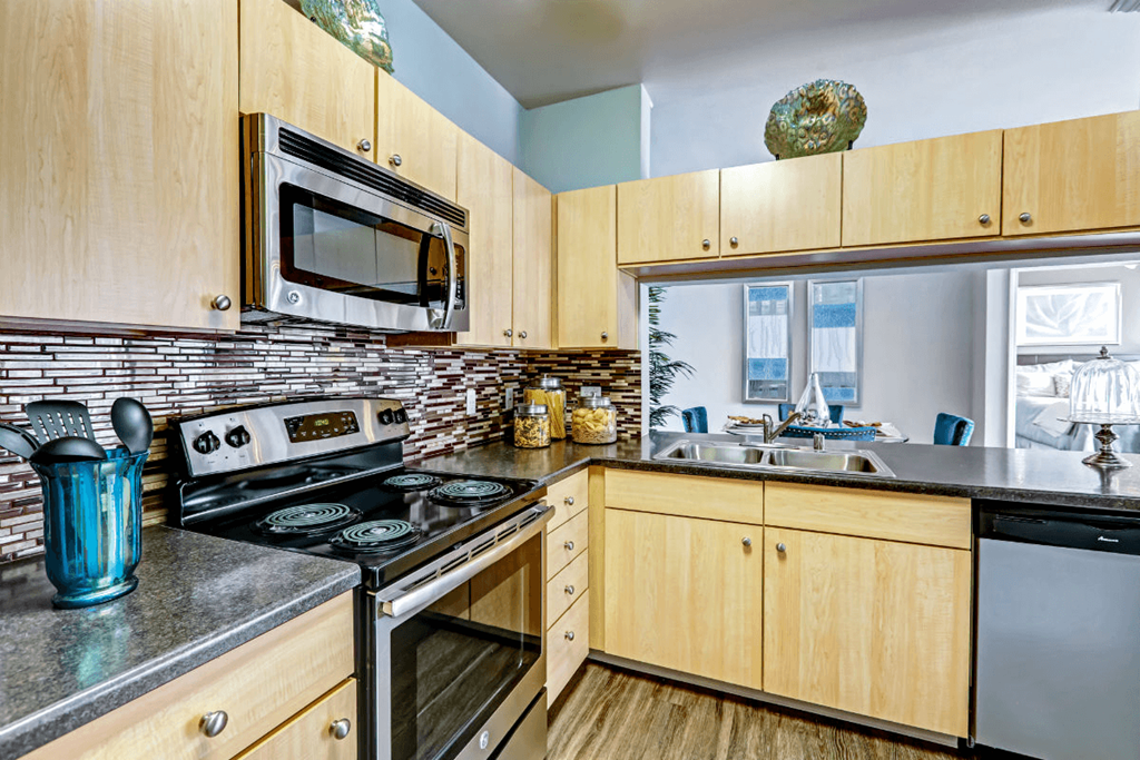 a kitchen with wooden cabinets and stainless steel appliances