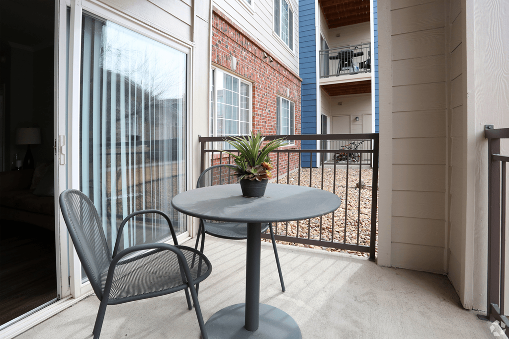 a small patio with a table and two chairs