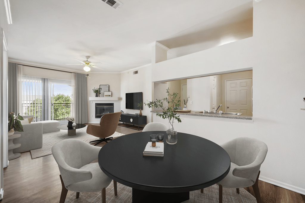 a living room with a table and chairs