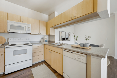 a kitchen with white appliances and wooden cabinets