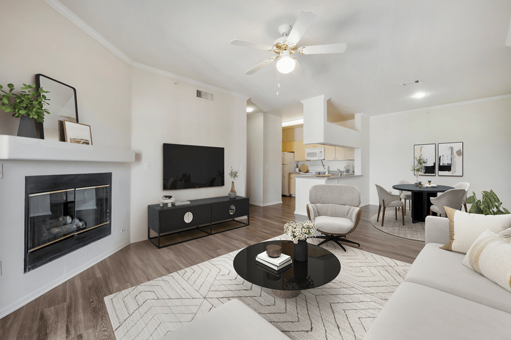 a living room with a fireplace and a flat screen tv