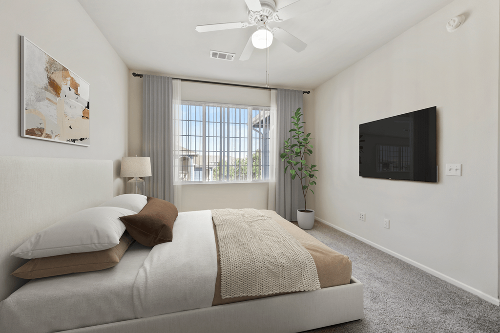 a bedroom with a large bed and a flat screen tv