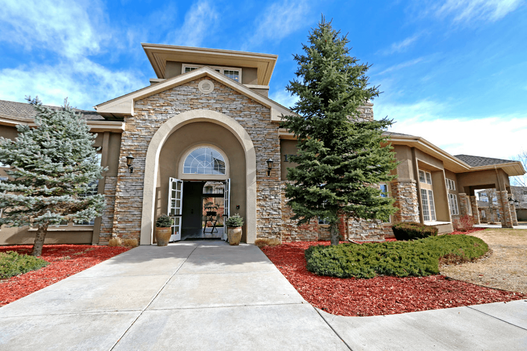 a home with a concrete walkway leading to the front door