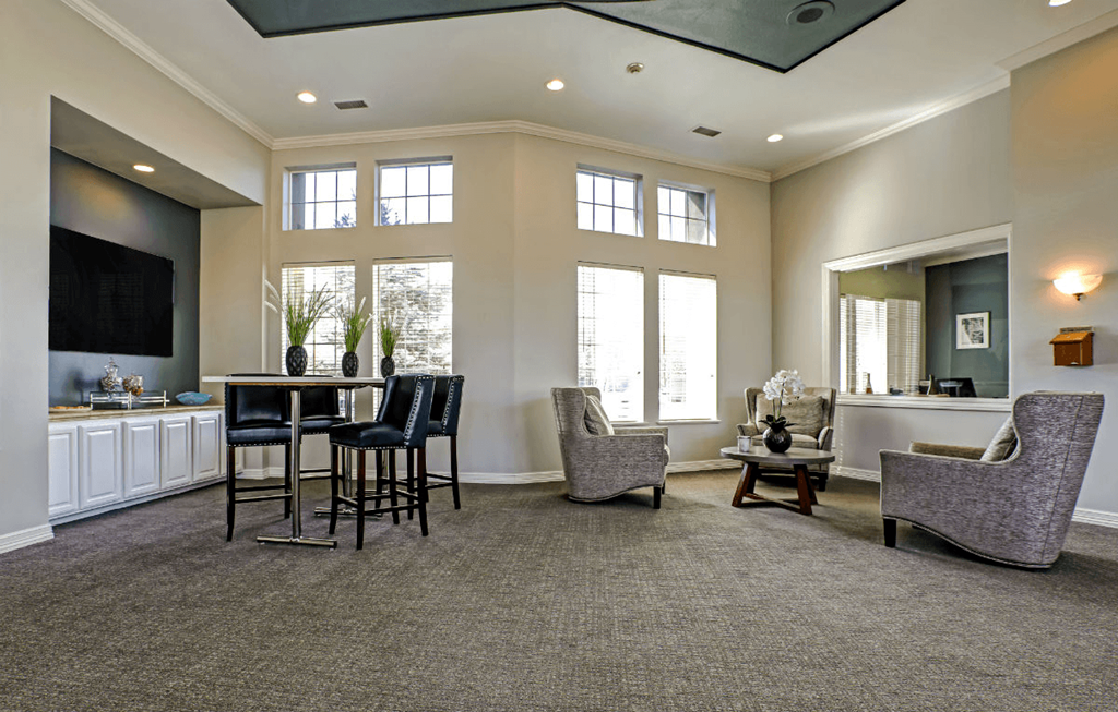 a living room filled with furniture and a large window