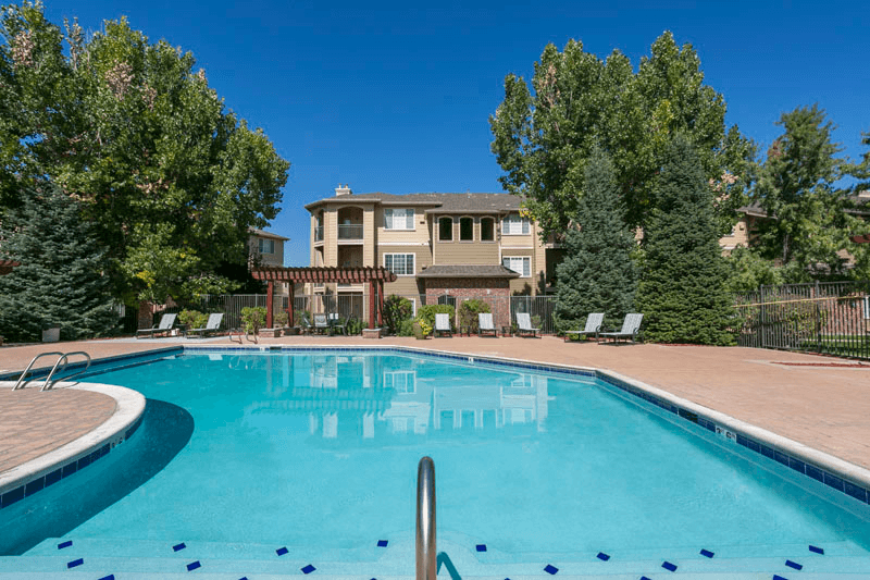 a swimming pool with a large house in the background