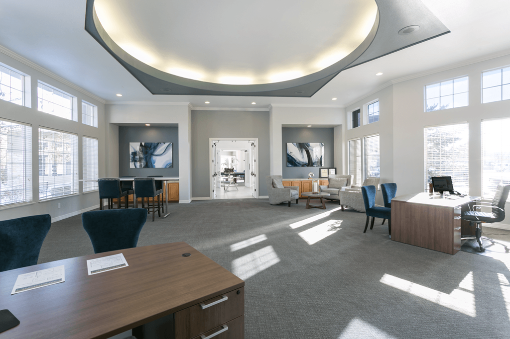 a large room with a desk and chairs