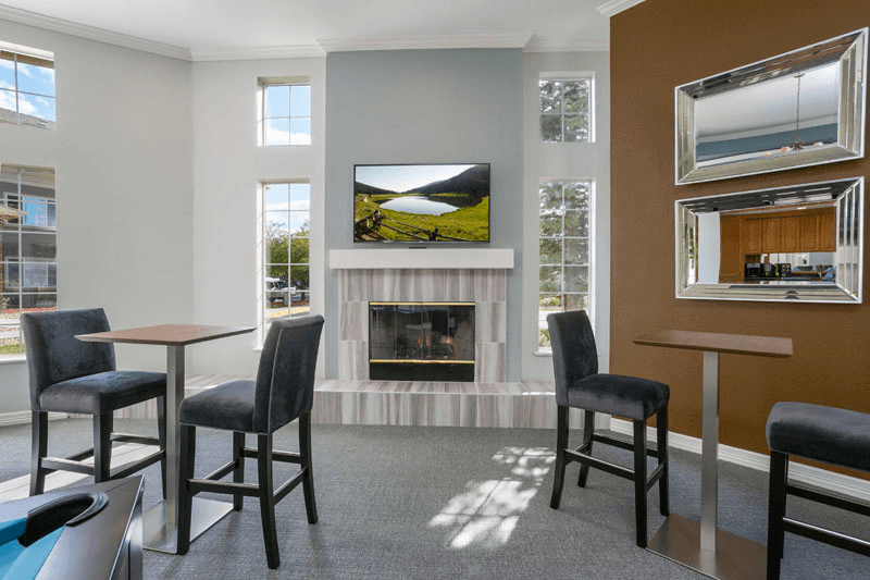 a living room with a fireplace and tv