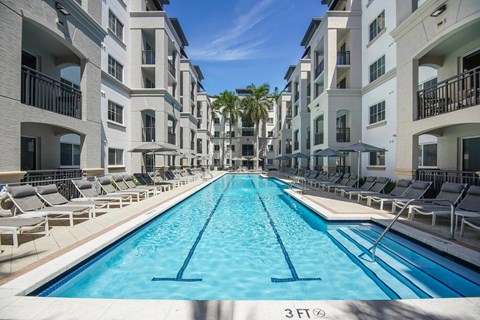 A swimming pool in front of apartment buildings.