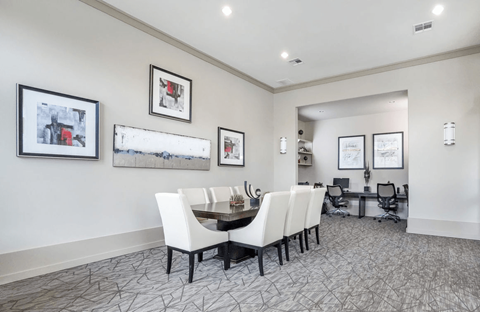 A dining room with a table and chairs.