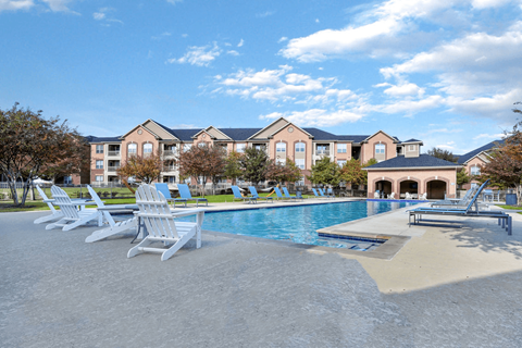 Swimming pool with large tanning deck and native surround landscape