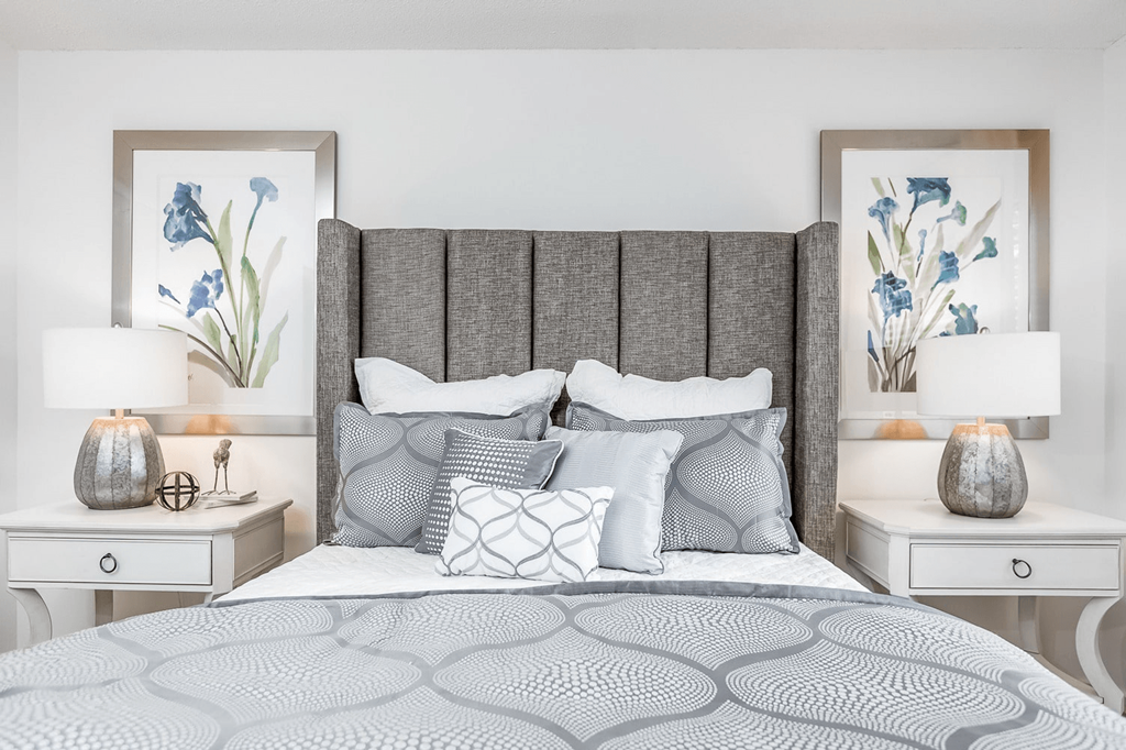 A bed with a grey headboard and a grey patterned bedspread at Regency Park Apartment Homes, Raleigh, North Carolina