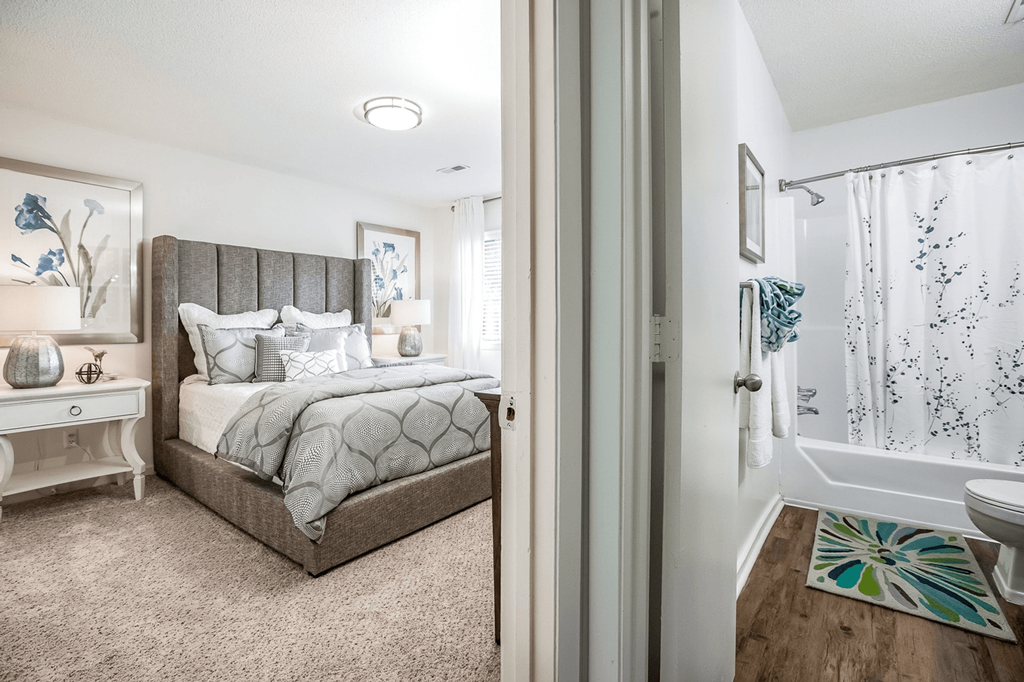 A bedroom with a large bed and a bathroom with a shower at Regency Park Apartment Homes, North Carolina