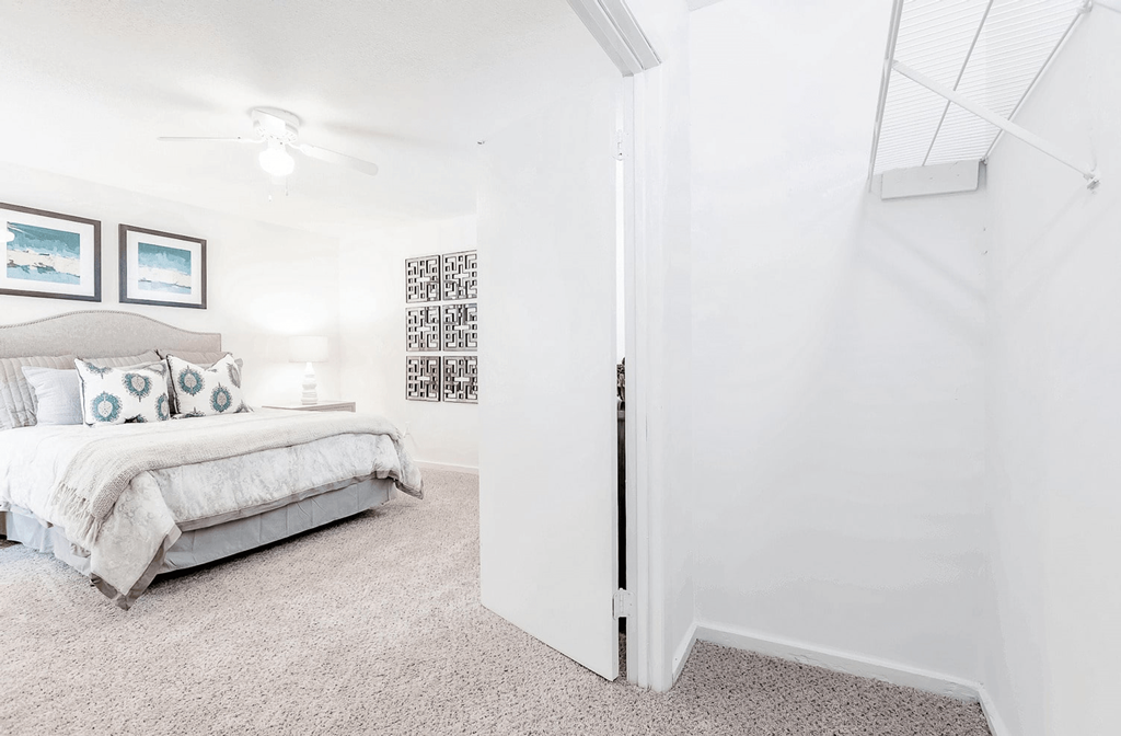 A bedroom with a bed and a wall hanging picture at Regency Park Apartment Homes, North Carolina, 27616