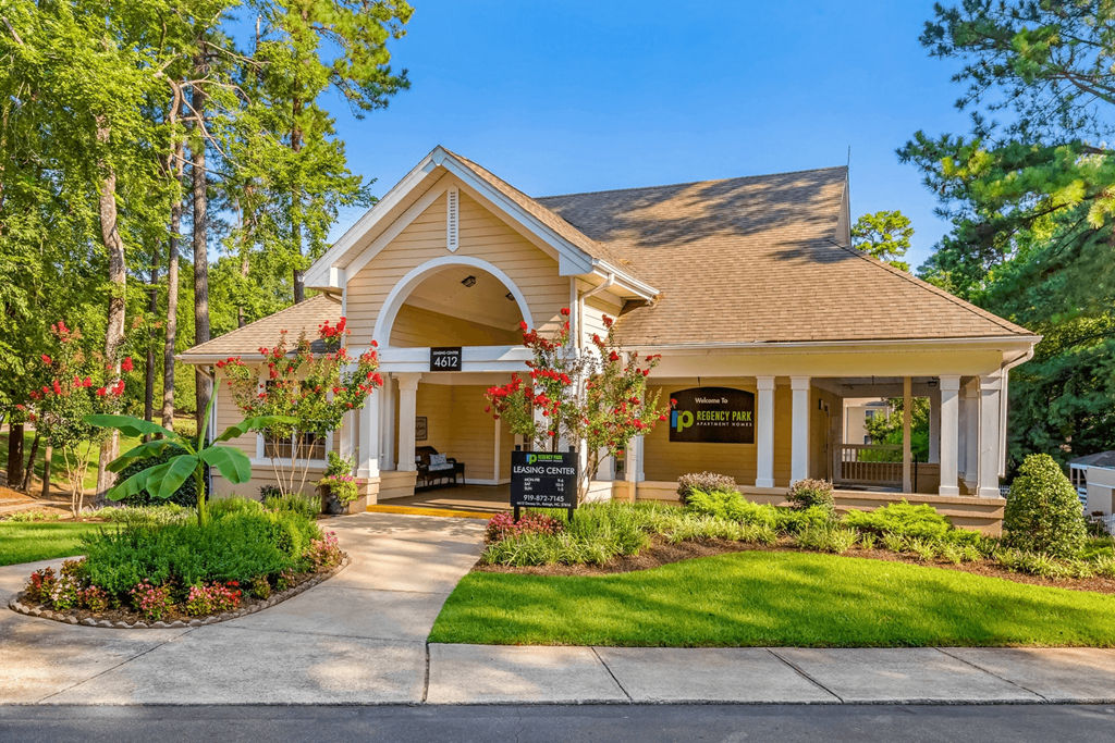 A house with a brown roof and a sign at Regency Park Apartment Homes, Raleigh, NC, 27616