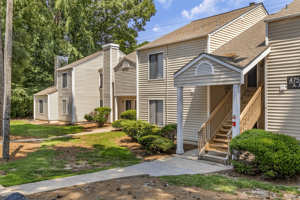A house numbered 475 with a front porch and steps leading to the front door
