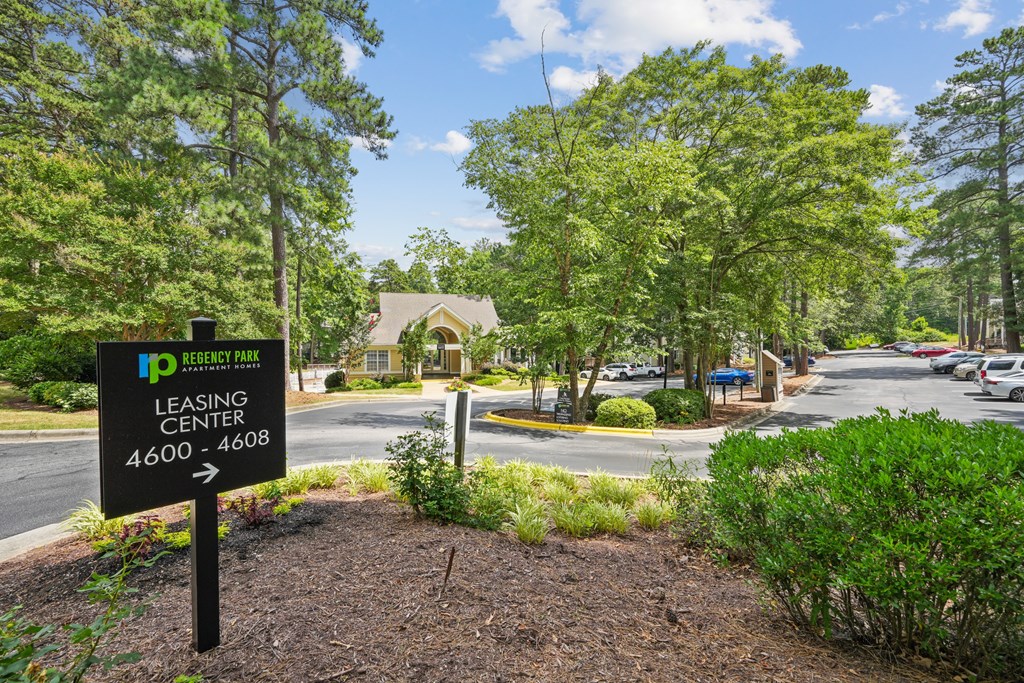 A sign for the Ip Leasing Center stands in front of a building at Regency Park Apartment Homes, North Carolina