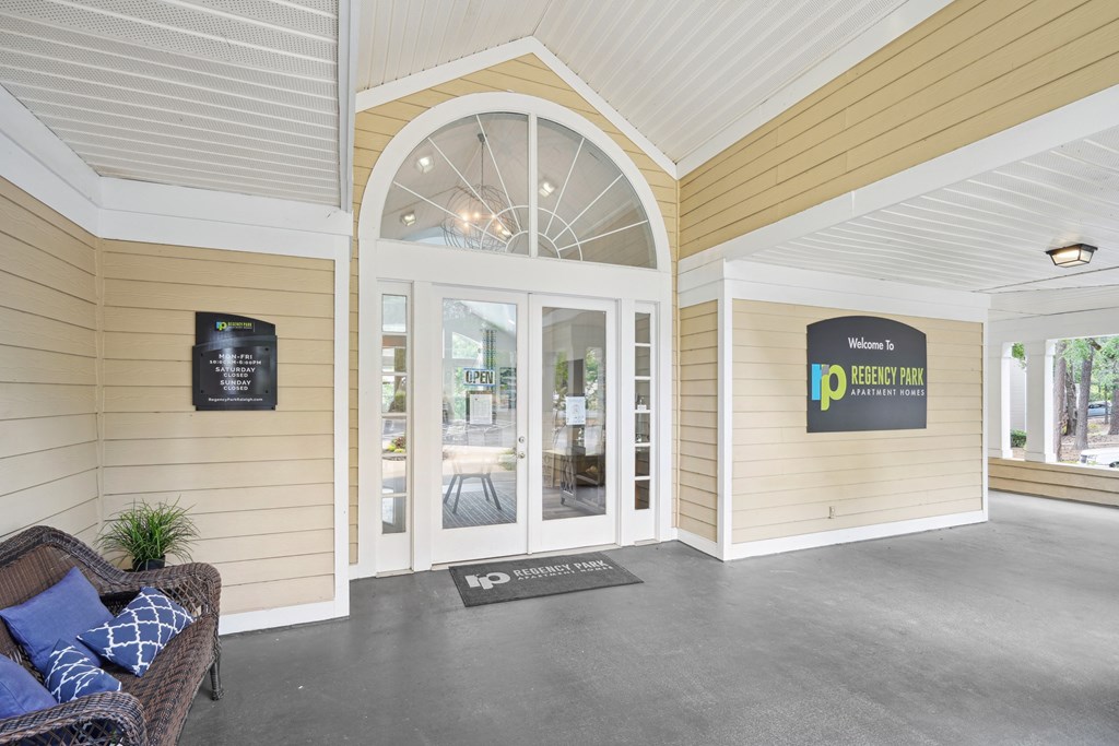 A welcoming entrance to a residential building with a sign on the wall at Regency Park Apartment Homes, Raleigh, 27616