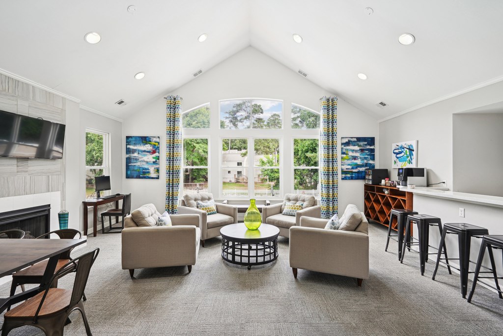 A living room with a fireplace and a large window at Regency Park Apartment Homes, Raleigh, North Carolina