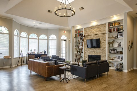 a living room with couches chairs and a fireplace