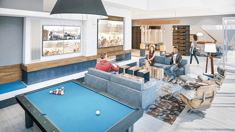 A group of people are gathered in a room with a pool table.