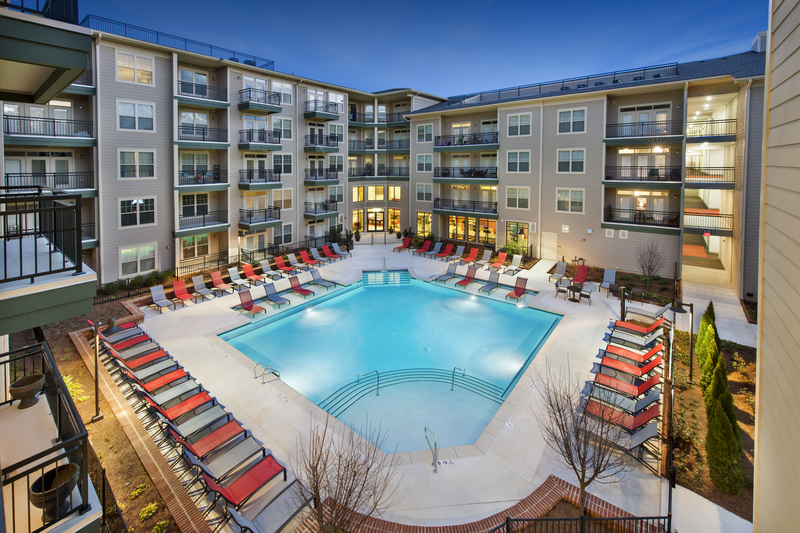 Swimming pool with large tanning deck and native surround landscape