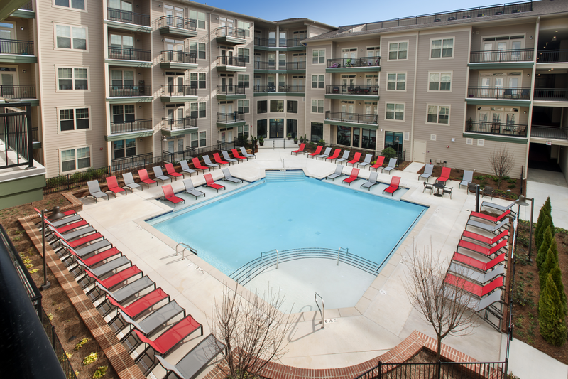 Swimming pool with large tanning deck and native surround landscape