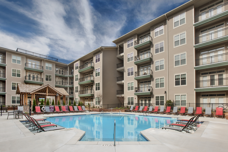 Swimming pool tanning deck facing exterior of apartments