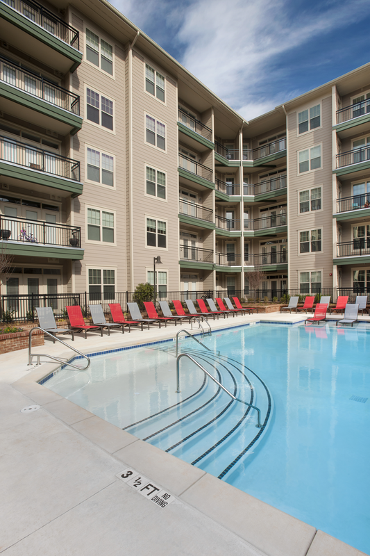 Swimming pool with large tanning deck and native surround landscape