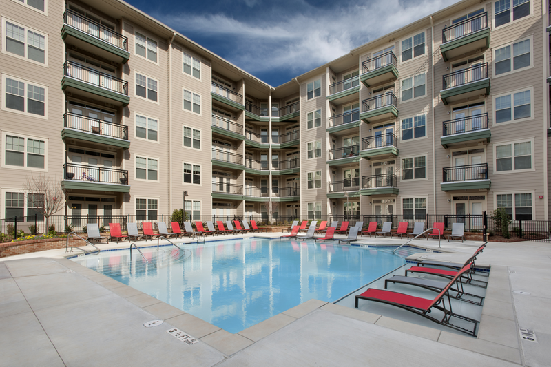 Swimming pool with large tanning deck and native surround landscape